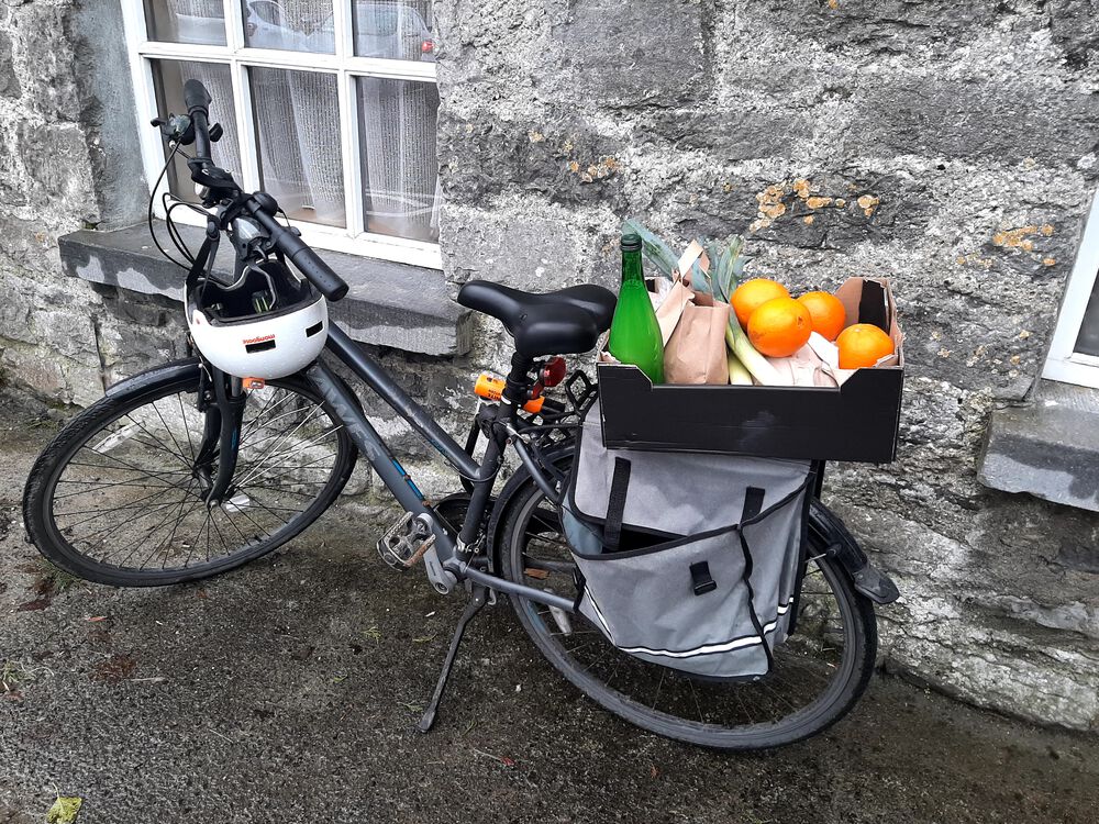 Photo of a bike with fresh product on the back carrier
